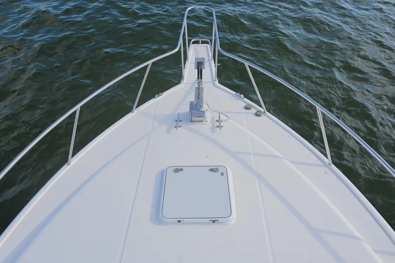 Done Deal Yacht Photos Pics Bow view of 2001 Cabo 35 Express boat on water.