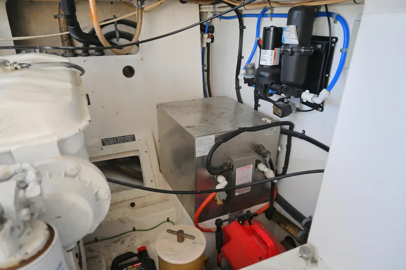 Done Deal Yacht Photos Pics Engine room of 2001 Cabo 35 Express boat with mechanical components and wiring.