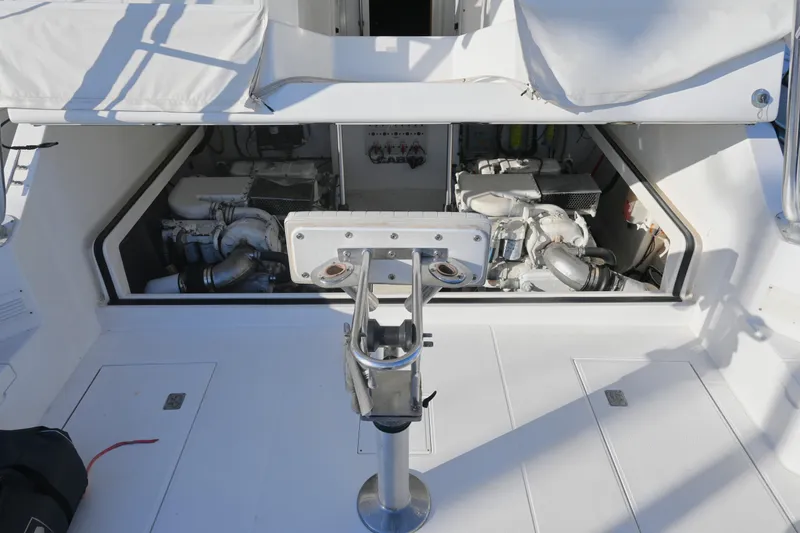 Done Deal Yacht Photos Pics 2001 Cabo 35 Express engine compartment with open hatch, showcasing dual engines.