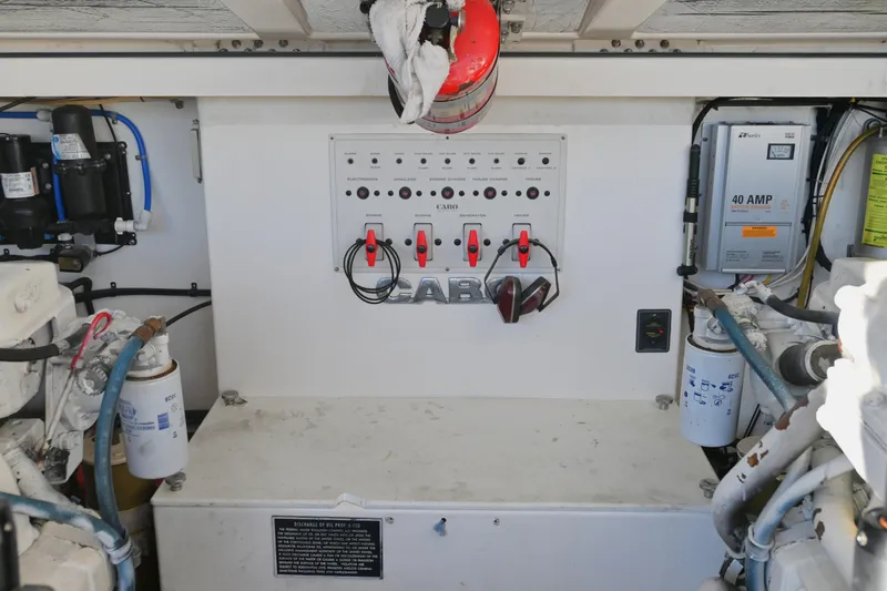 Done Deal Yacht Photos Pics Engine room of 2001 Cabo 35 Express boat with control panel and equipment.