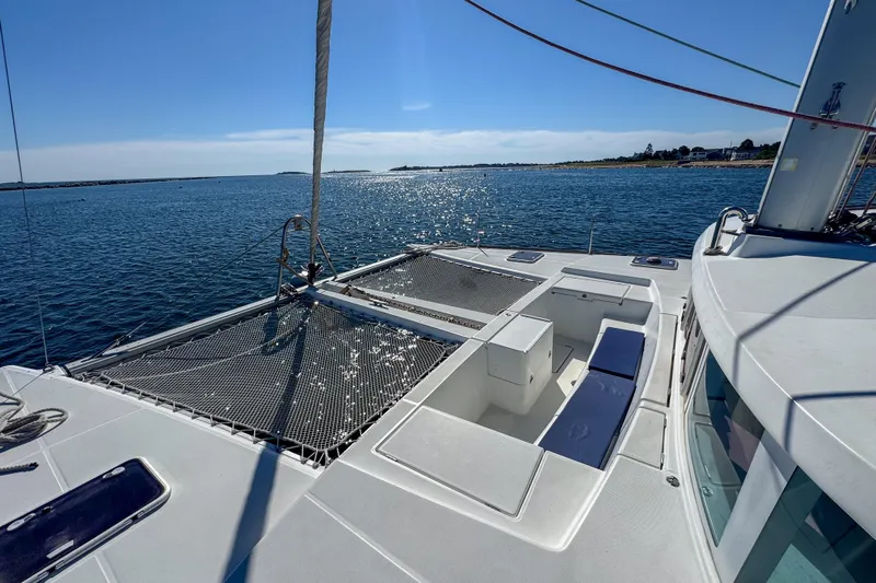 Liberty Yacht Photos Pics 2005 Lagoon 440 catamaran on calm water, featuring spacious deck and netting.