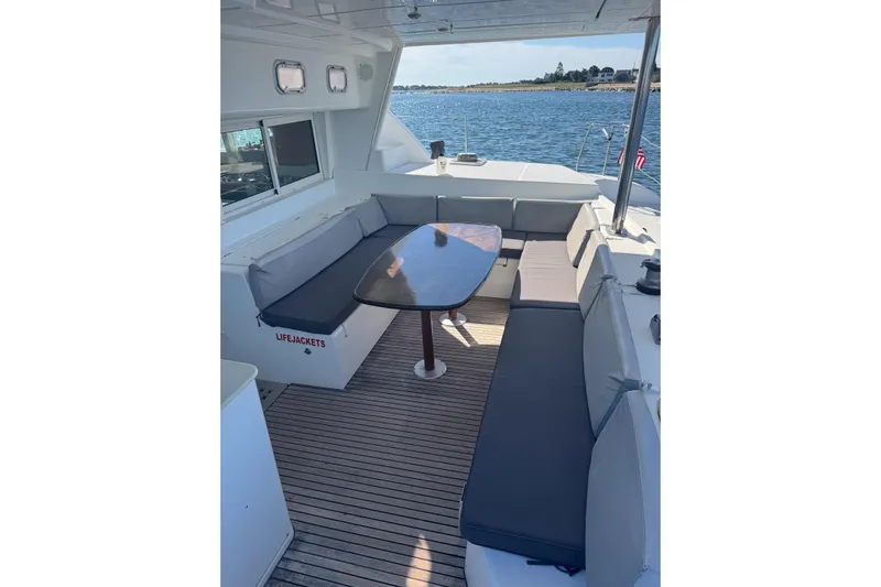 Liberty Yacht Photos Pics Spacious deck seating on 2005 Lagoon 440 catamaran with ocean view.