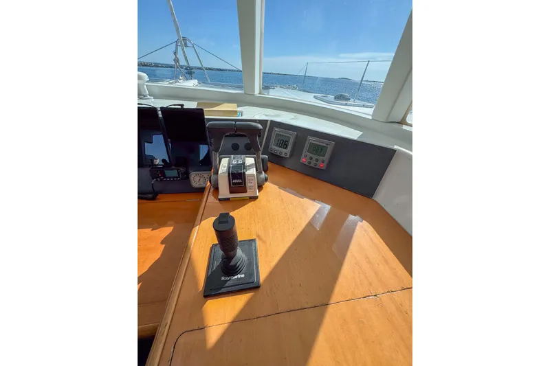 Liberty Yacht Photos Pics Helm of 2005 Lagoon 440 catamaran with navigation controls and ocean view.
