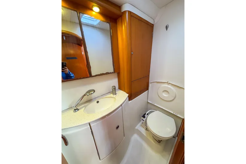 Liberty Yacht Photos Pics Bathroom interior of 2005 Lagoon 440 yacht with sink, mirror, and toilet.