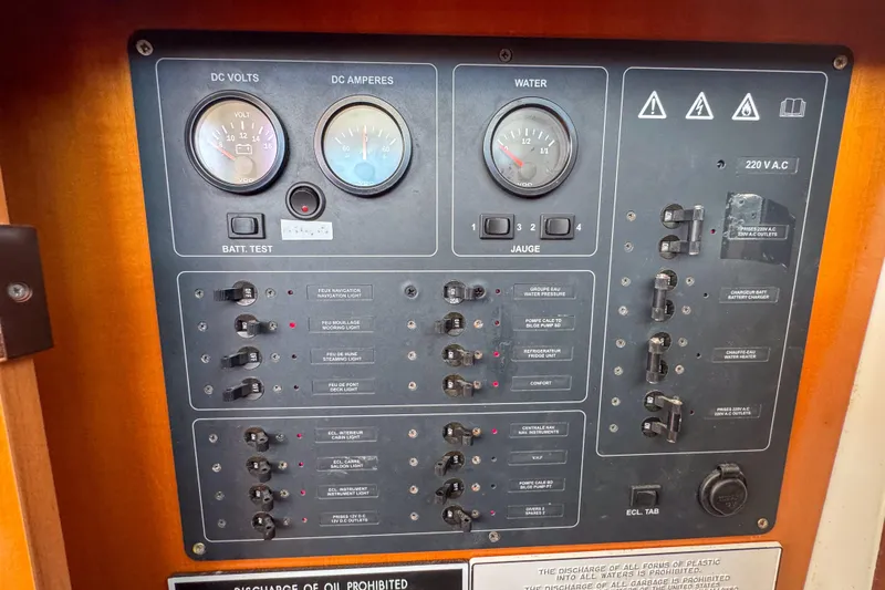 Liberty Yacht Photos Pics Electrical control panel of a 2005 Lagoon 440 catamaran, featuring gauges and switches.