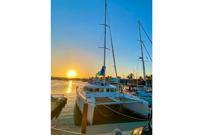 Liberty Yacht Photos Pics Lagoon 440 catamaran docked at sunset, 2005 model, serene marina view.