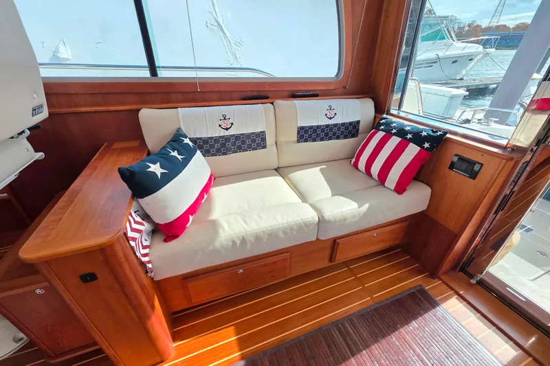  Yacht Photos Pics Cozy interior of 2017 Sabre 42 Salon Express with nautical-themed cushions.