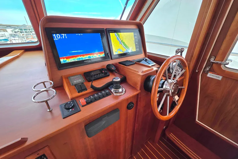  Yacht Photos Pics 2017 Sabre 42 Salon Express helm with navigation screens and wooden steering wheel.