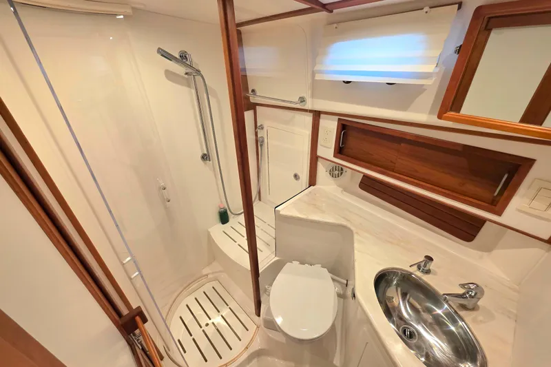 Yacht Photos Pics Luxurious bathroom in 2017 Sabre 42 Salon Express yacht with shower and sink.