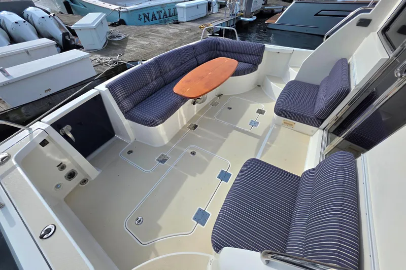 Yacht Photos Pics 2017 Sabre 42 Salon Express yacht cockpit with striped seating and wooden table.