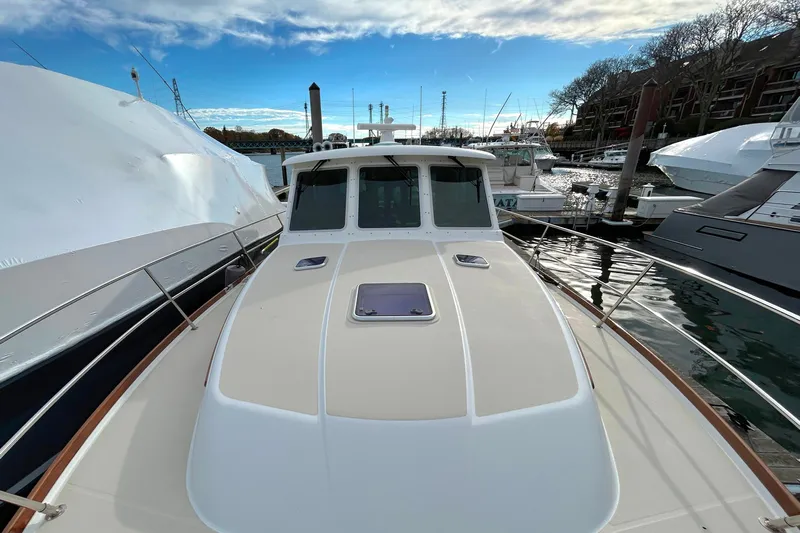  Yacht Photos Pics 2017 Sabre 42 Salon Express yacht docked at marina under blue sky.