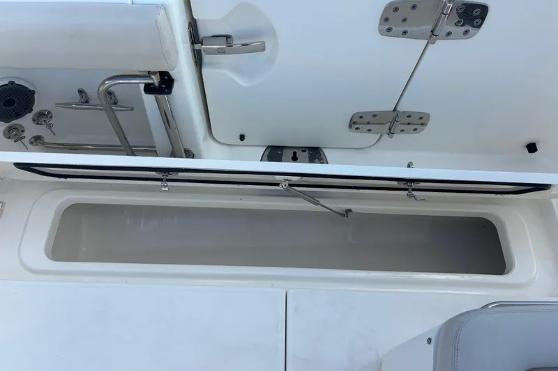  Yacht Photos Pics 2021 Boston Whaler 330 Outrage boat storage compartment with stainless steel fixtures.