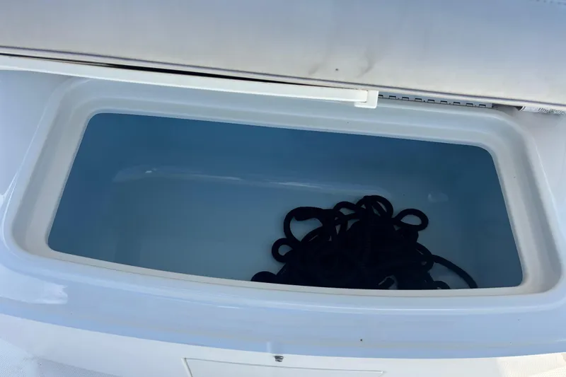  Yacht Photos Pics Open storage compartment on 2021 Boston Whaler 330 Outrage boat with coiled rope inside.