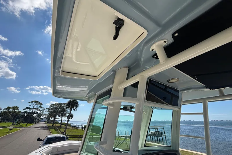  Yacht Photos Pics 2021 Boston Whaler 330 Outrage boat interior with ocean view and clear sky.