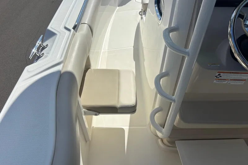  Yacht Photos Pics 2021 Boston Whaler 330 Outrage boat interior with seating and steering details.