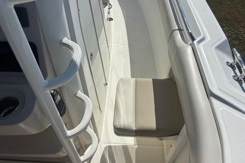  Yacht Photos Pics 2021 Boston Whaler 330 Outrage boat interior with seating and handrails.