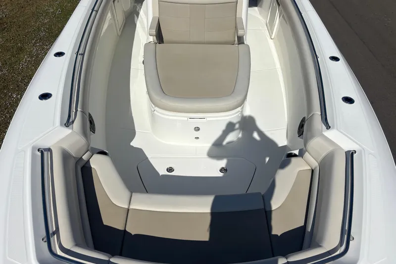  Yacht Photos Pics 2021 Boston Whaler 330 Outrage boat interior with cushioned seating and sleek design.