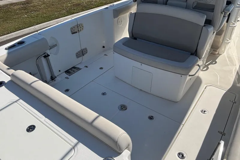  Yacht Photos Pics 2021 Boston Whaler 330 Outrage boat interior with seating and storage compartments.