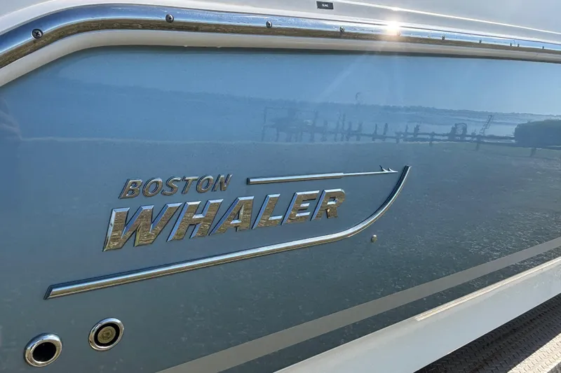  Yacht Photos Pics 2021 Boston Whaler 330 Outrage boat logo on blue hull.