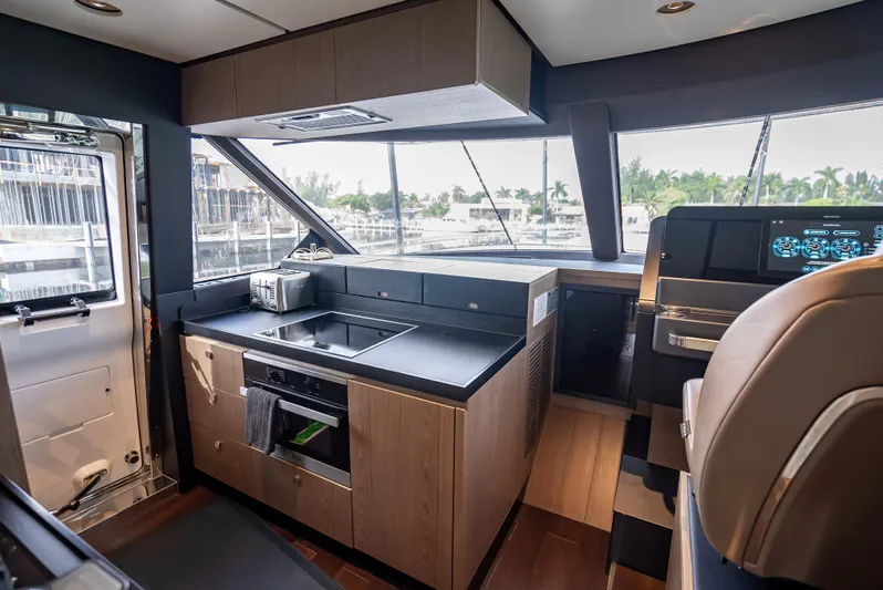 Triangle Of The Seas Yacht Photos Pics Interior of 2022 Azimut Magellano 66 yacht, featuring modern kitchen and navigation area.