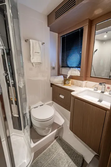 Triangle Of The Seas Yacht Photos Pics Luxurious bathroom in 2022 Azimut Magellano 66 yacht, featuring modern fixtures and elegant design.