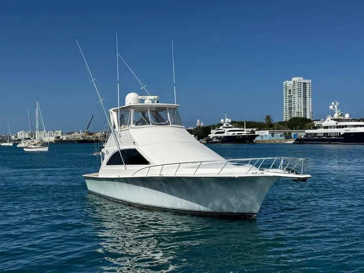 Nana Yacht Photos Pics Ocean Yachts 48 Convertible 2000 model in a marina, clear blue sky background.