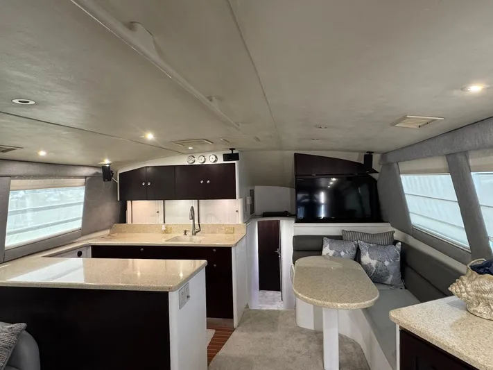Nana Yacht Photos Pics Interior of 2000 Ocean Yachts 48 Convertible with modern kitchen and seating area.