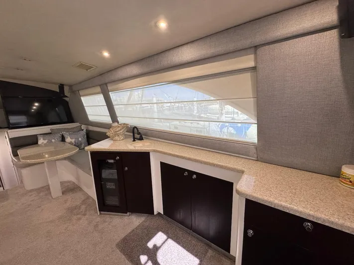 Nana Yacht Photos Pics Interior of 2000 Ocean Yachts 48 Convertible, featuring modern cabinetry and large windows.