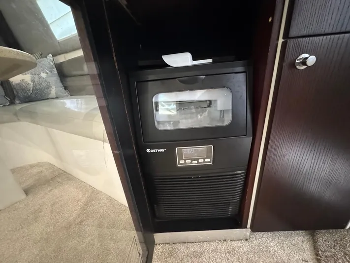 Nana Yacht Photos Pics Ice maker inside 2000 Ocean Yachts 48 Convertible, with dark wood cabinetry.