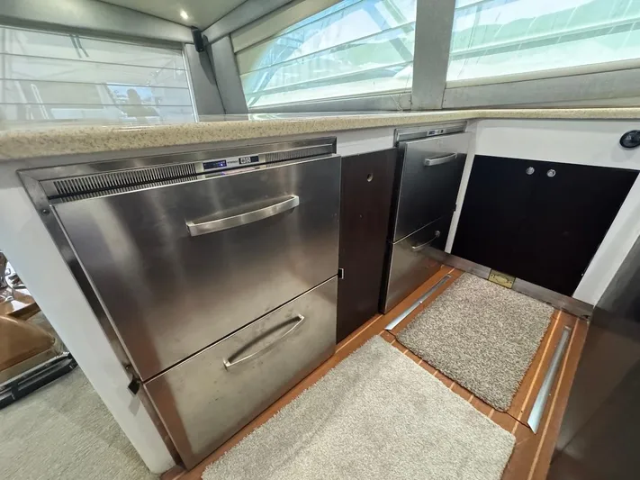 Nana Yacht Photos Pics Interior of 2000 Ocean Yachts 48 Convertible, featuring stainless steel appliances and modern design.