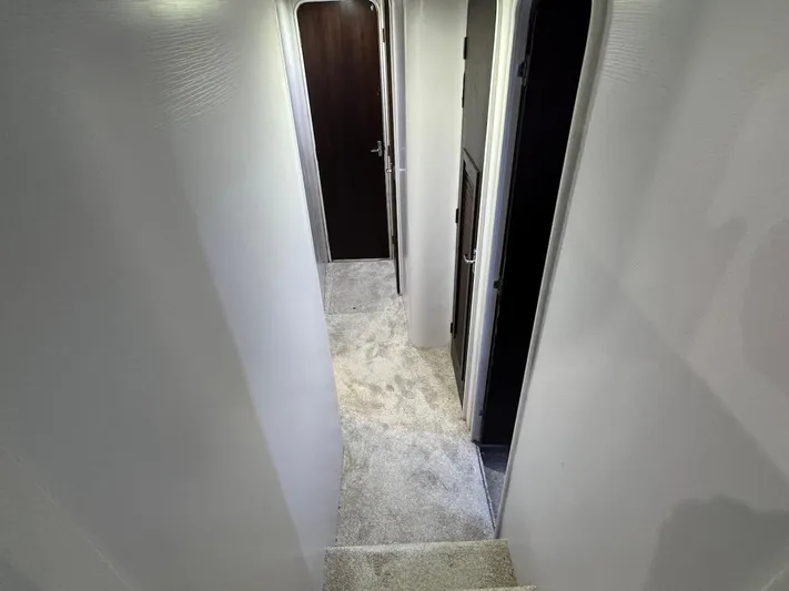 Nana Yacht Photos Pics Interior hallway of 2000 Ocean Yachts 48 Convertible, featuring carpeted flooring and doorways.