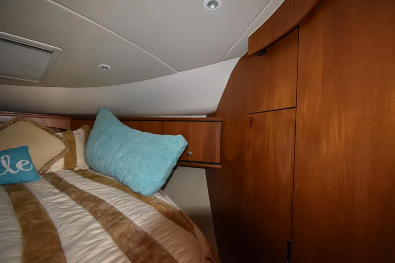  Yacht Photos Pics 2008 Tiara Yachts 39 Sovran cabin interior with cozy bedding and wooden cabinetry.
