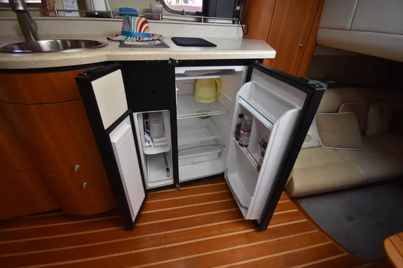  Yacht Photos Pics 2008 Tiara Yachts 39 Sovran interior with open fridge, wooden flooring, and cozy seating area.