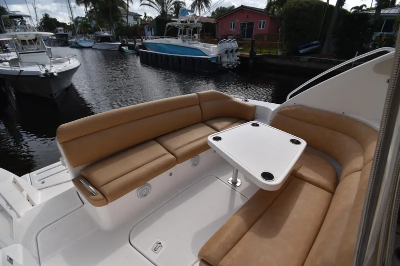  Yacht Photos Pics 2008 Tiara Yachts 39 Sovran cockpit with tan seating and table, docked by a canal.