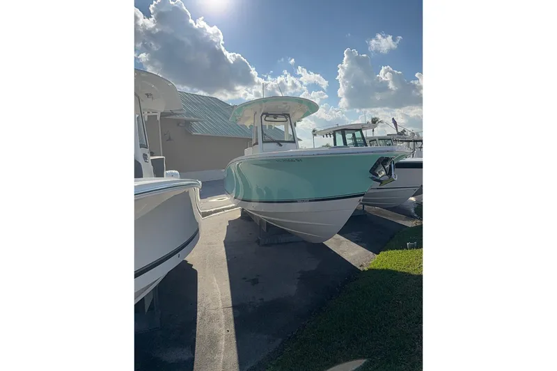 28-563 Brokerage Higgins Yacht Photos Pics 2021 Regulator 28 boat displayed outdoors under a bright sky.