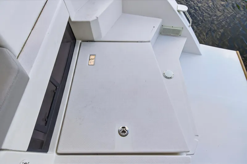  Yacht Photos Pics 2022 Leopard 45 yacht deck with storage compartment and steps, near water.