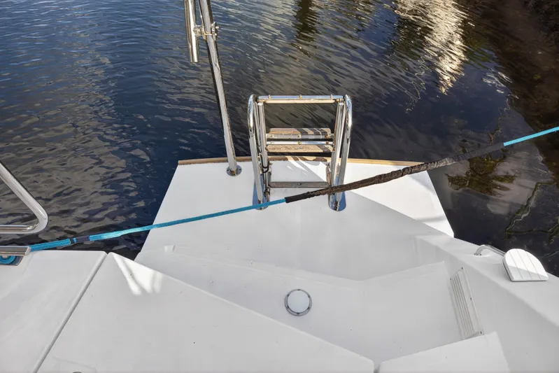  Yacht Photos Pics Stern view of 2022 Leopard 45 catamaran with swim ladder and mooring line.