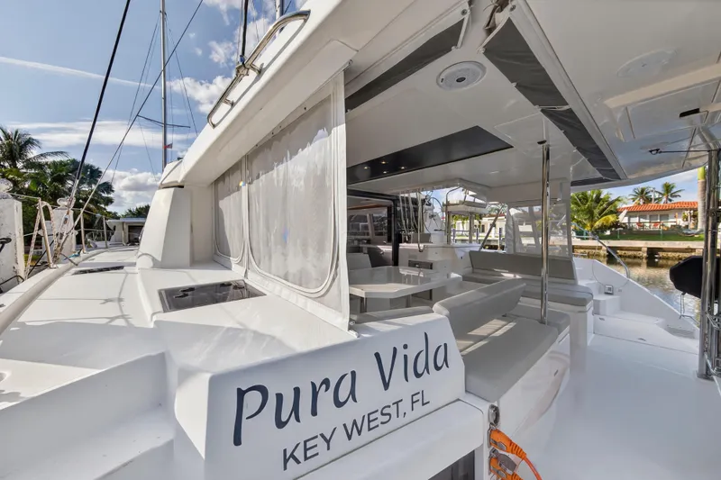  Yacht Photos Pics 2022 Leopard 45 catamaran docked in Key West, featuring spacious outdoor seating.