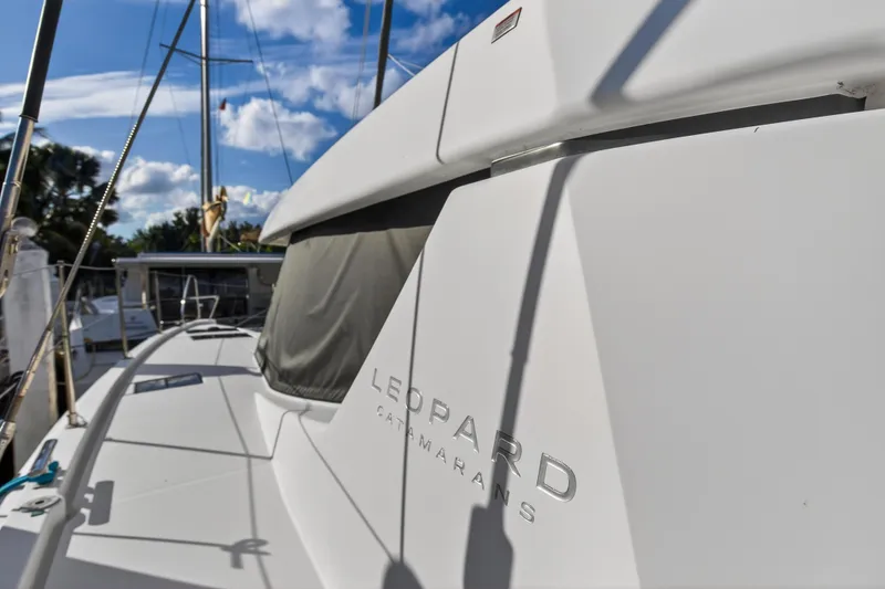  Yacht Photos Pics 2022 Leopard 45 catamaran docked under a clear blue sky.