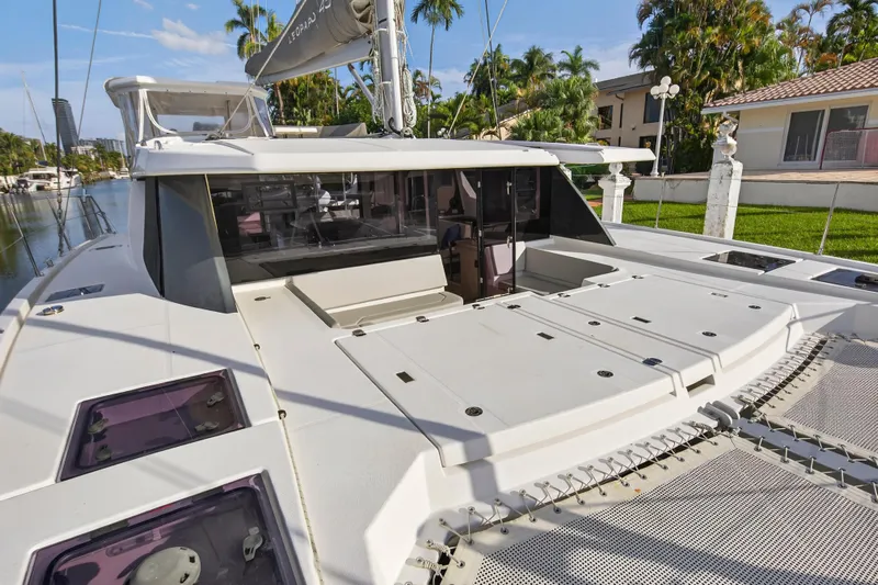  Yacht Photos Pics 2022 Leopard 45 catamaran docked, showcasing spacious deck and modern design.