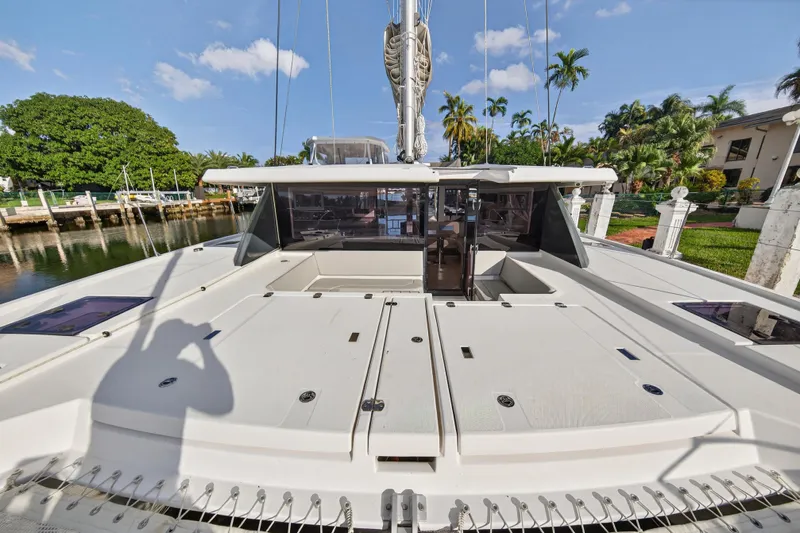  Yacht Photos Pics 2022 Leopard 45 catamaran docked, showcasing spacious deck and modern design.