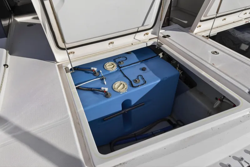  Yacht Photos Pics Open storage compartment on 2022 Leopard 45 boat, revealing blue tank and wiring.