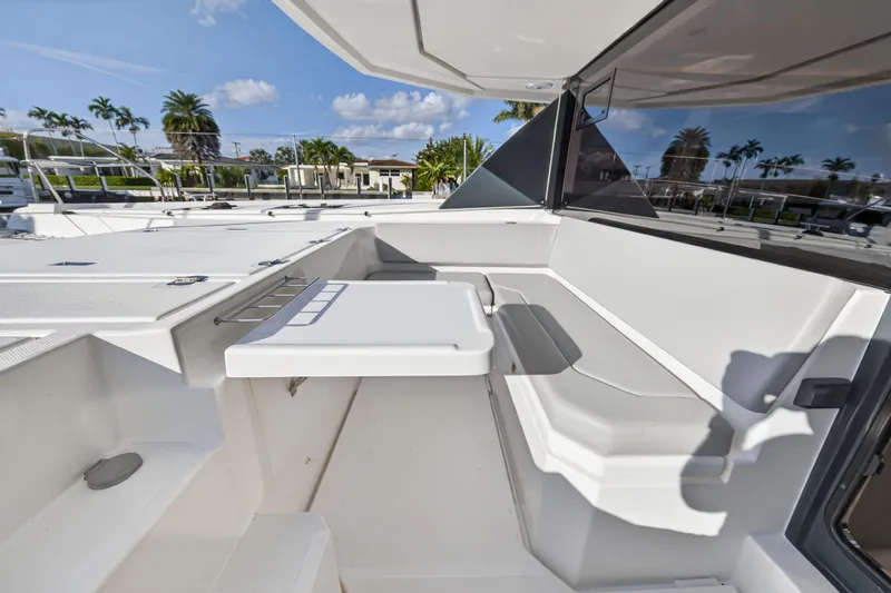  Yacht Photos Pics 2022 Leopard 45 yacht deck with seating area, table, and scenic view.
