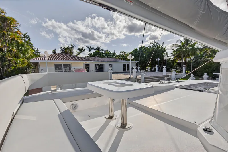  Yacht Photos Pics Luxury deck of 2022 Leopard 45 yacht with seating and table, surrounded by tropical scenery.