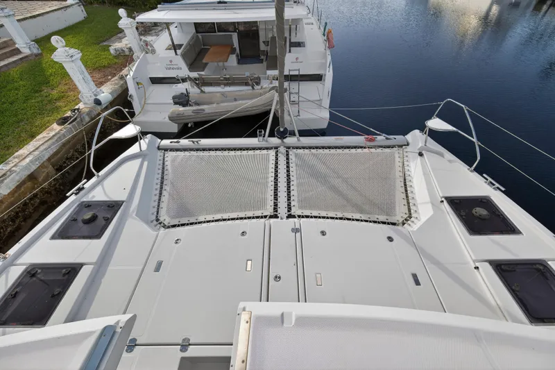  Yacht Photos Pics 2022 Leopard 45 catamaran docked, showcasing spacious deck and netting area.