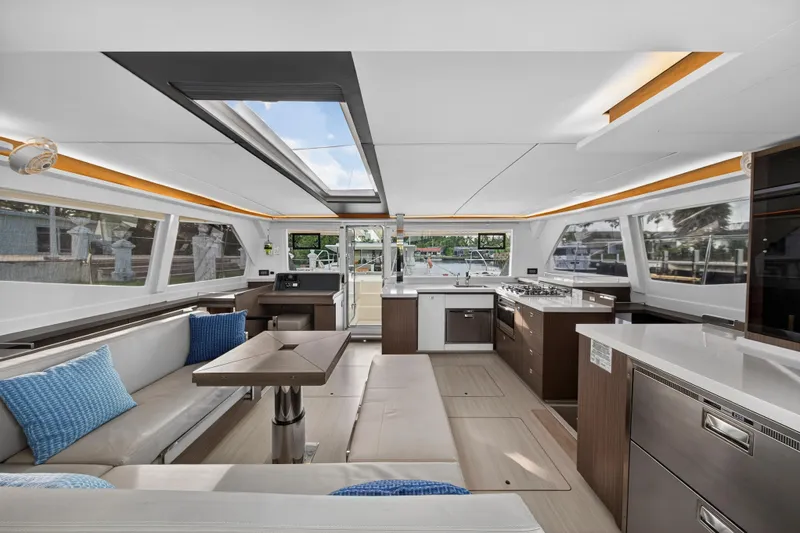  Yacht Photos Pics Luxurious interior of 2022 Leopard 45 catamaran with modern kitchen and seating area.