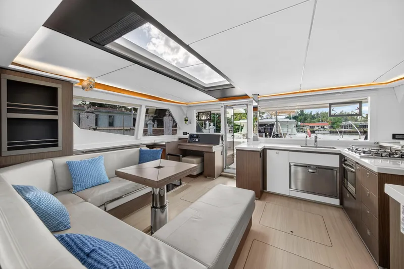  Yacht Photos Pics Luxurious interior of 2022 Leopard 45 catamaran with modern kitchen and seating area.