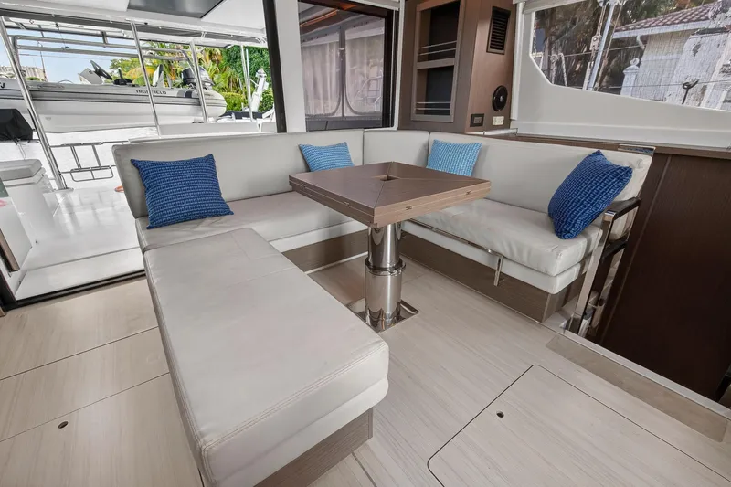  Yacht Photos Pics Luxurious interior of 2022 Leopard 45 yacht with white seating and blue cushions.