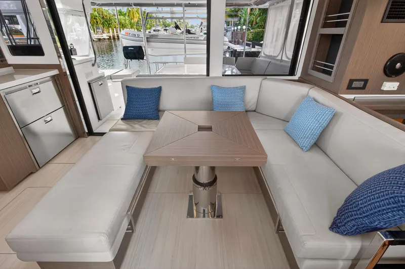  Yacht Photos Pics Luxurious interior of 2022 Leopard 45 yacht with modern seating and table.
