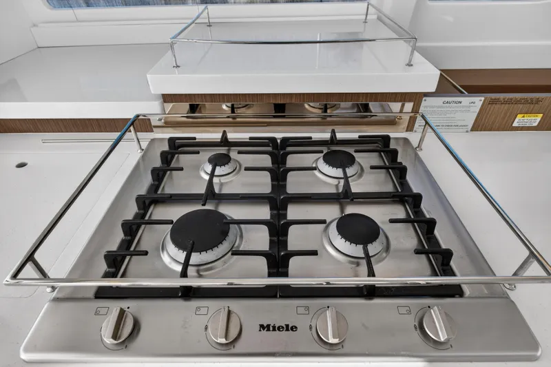 Yacht Photos Pics Modern kitchen stove in 2022 Leopard 45 yacht, featuring a sleek Miele gas cooktop.